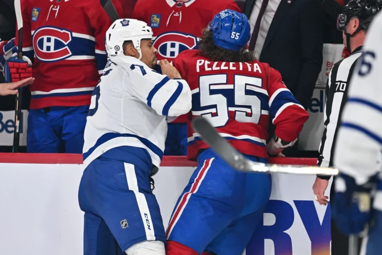 Michael Pezzetta, who has a separated shoulder, battles Ryan Reaves.